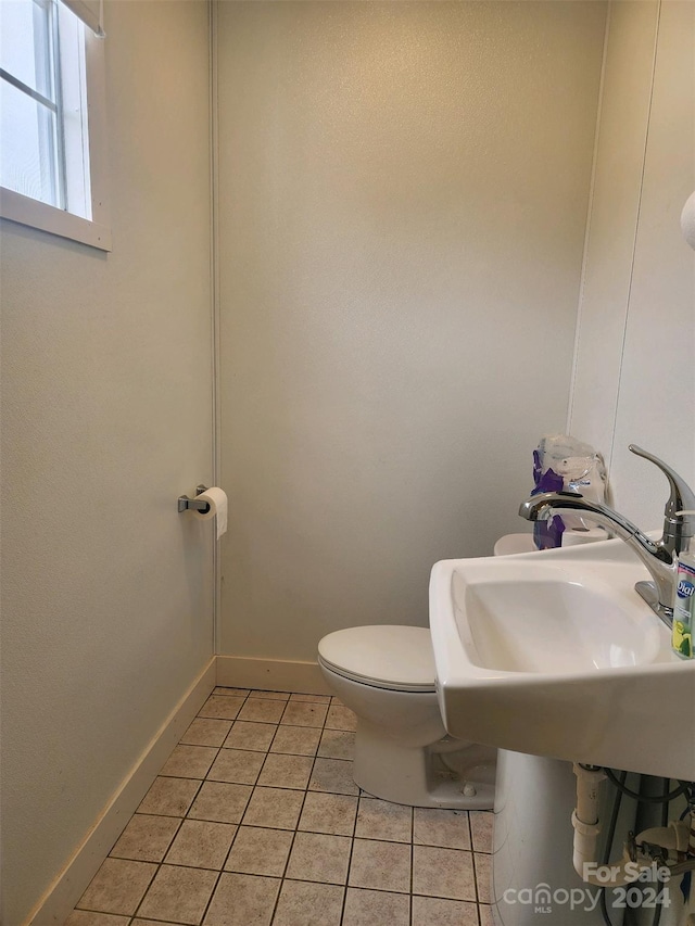 bathroom with sink, tile patterned flooring, and toilet