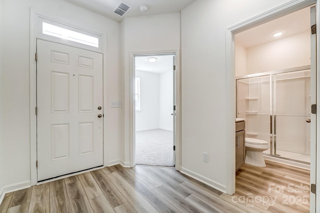 entryway with plenty of natural light and light hardwood / wood-style flooring