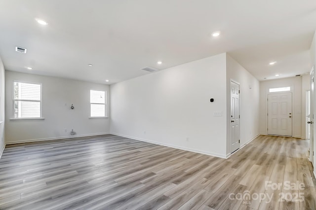 unfurnished room with light hardwood / wood-style flooring