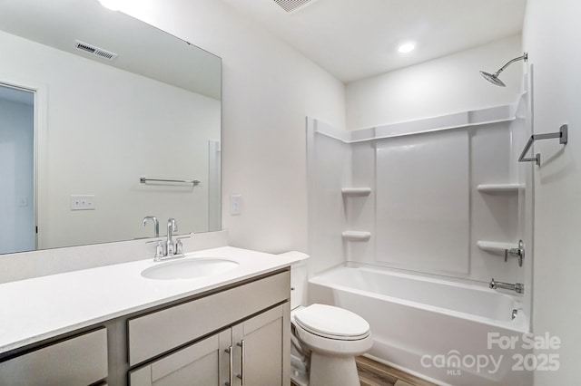 full bathroom featuring vanity, toilet, shower / bath combination, and hardwood / wood-style floors