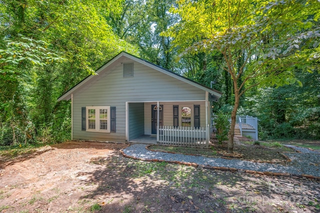 rear view of property with a porch