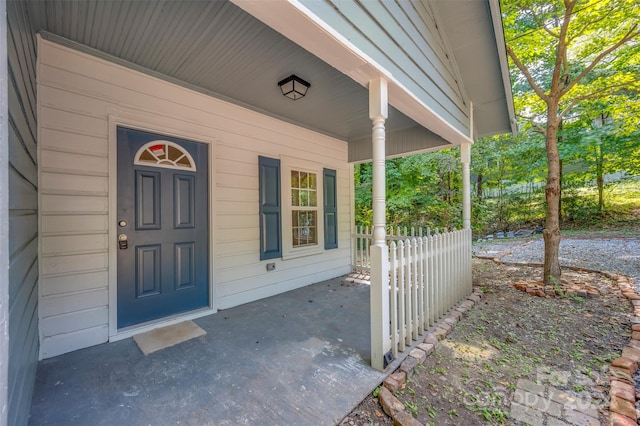 doorway to property featuring covered porch