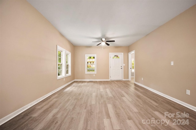 spare room featuring light hardwood / wood-style flooring and ceiling fan