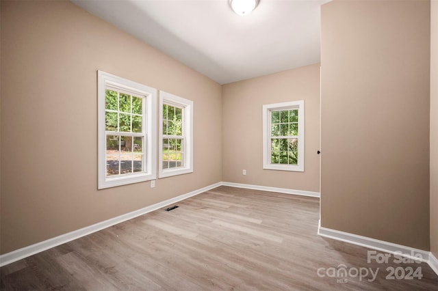 unfurnished room with wood-type flooring