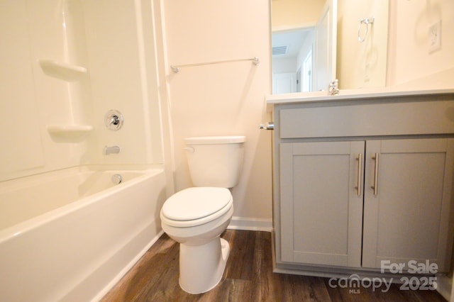bathroom with wood finished floors, vanity, shower / bath combination, toilet, and visible vents