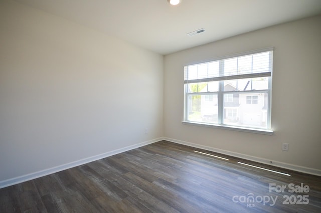 spare room featuring recessed lighting, visible vents, baseboards, and dark wood-style flooring