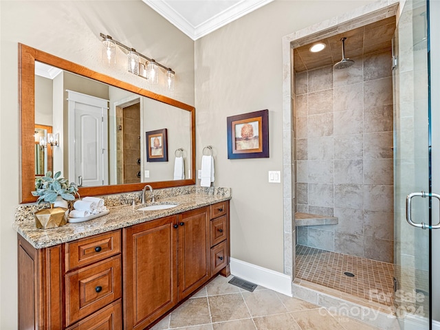 bathroom with ornamental molding, vanity, an enclosed shower, and tile patterned flooring