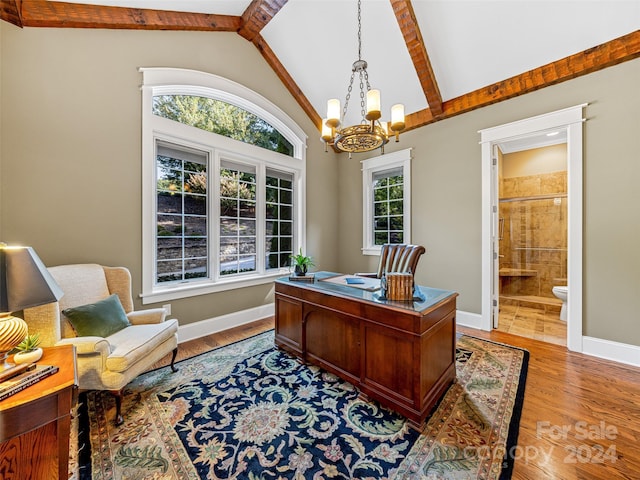 office with lofted ceiling with beams, plenty of natural light, and light hardwood / wood-style flooring