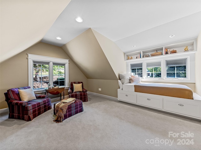 sitting room featuring vaulted ceiling and light colored carpet