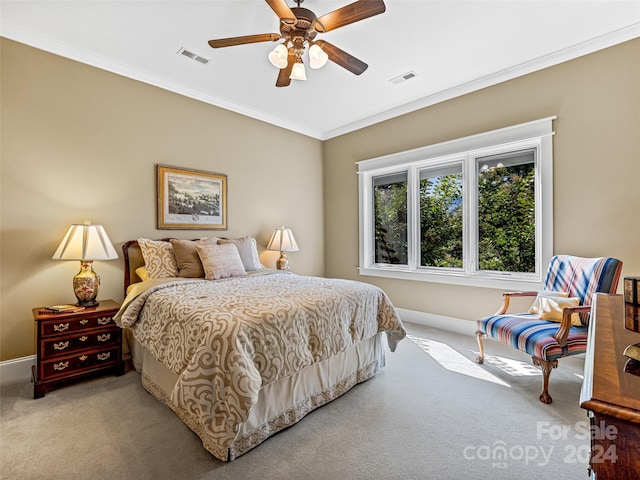 bedroom featuring crown molding, light colored carpet, and ceiling fan