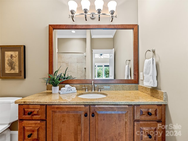 bathroom featuring crown molding, vanity, and toilet