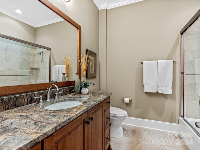 full bathroom with crown molding, tile patterned floors, toilet, combined bath / shower with glass door, and vanity