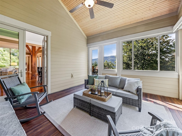 sunroom featuring lofted ceiling, wooden ceiling, and ceiling fan