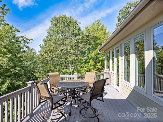 wooden deck with outdoor dining space