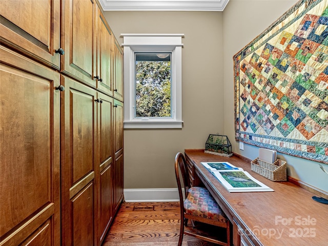 office space featuring ornamental molding, baseboards, and wood finished floors