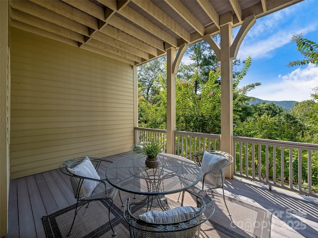 wooden deck with outdoor dining area