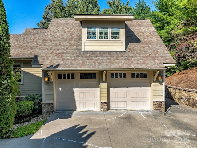 garage featuring concrete driveway