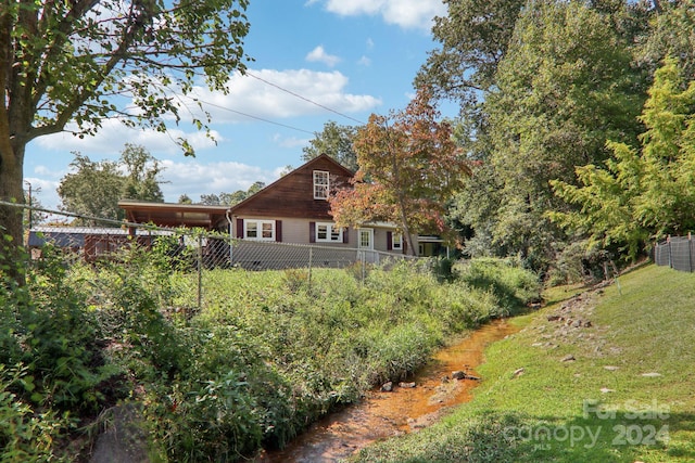 rear view of house featuring a yard