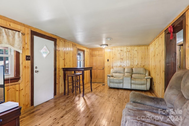 living room with wood walls and light hardwood / wood-style floors