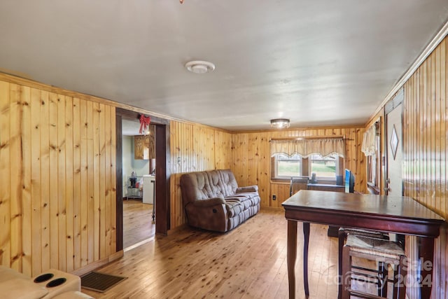 living room featuring wood-type flooring and wood walls