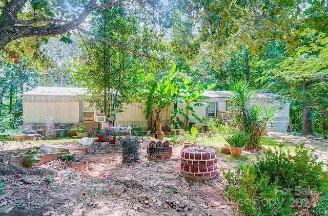 view of yard with a fire pit