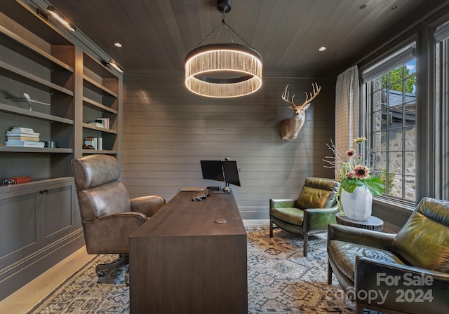 office area with built in shelves, wood walls, and wood ceiling