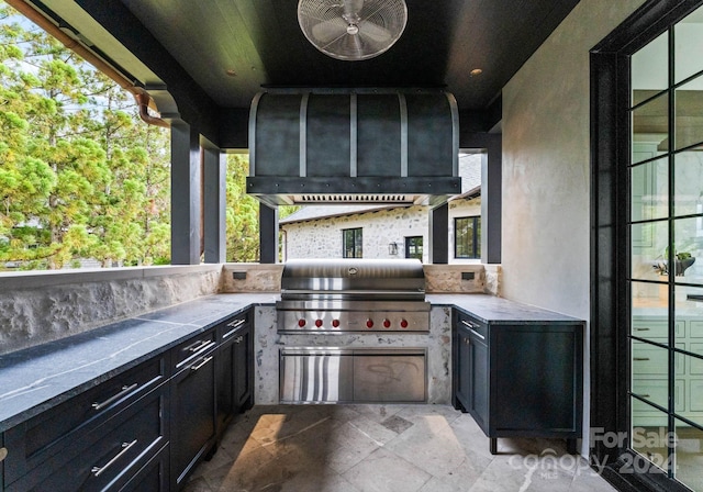 view of patio / terrace with a grill, an outdoor kitchen, and ceiling fan