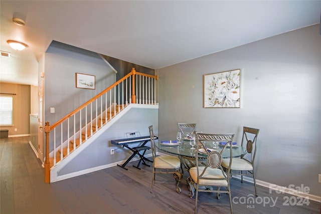 dining space with hardwood / wood-style floors