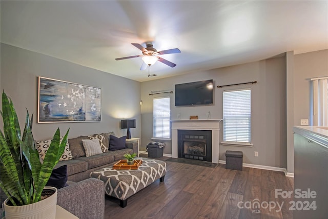 living room with dark wood-type flooring and ceiling fan