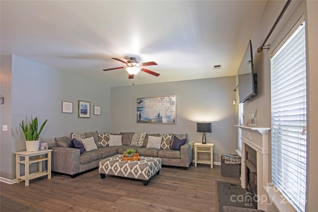 living room with ceiling fan and dark hardwood / wood-style floors