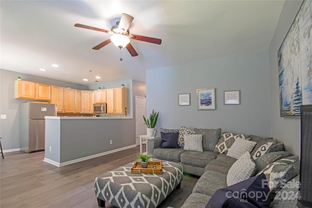 living room with hardwood / wood-style floors and ceiling fan