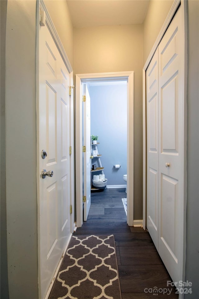 hall with dark wood-type flooring