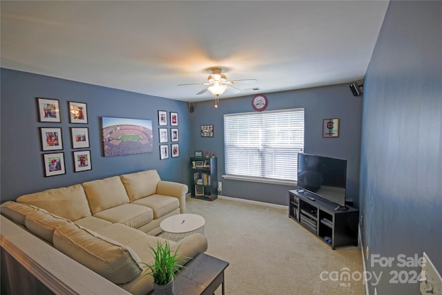 carpeted living room with ceiling fan