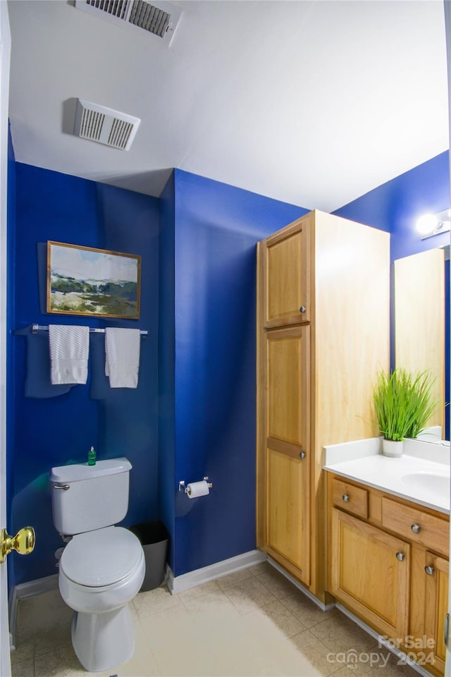 bathroom featuring vanity, toilet, and tile patterned flooring