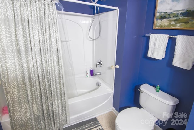 bathroom featuring toilet, shower / tub combo, and tile patterned flooring