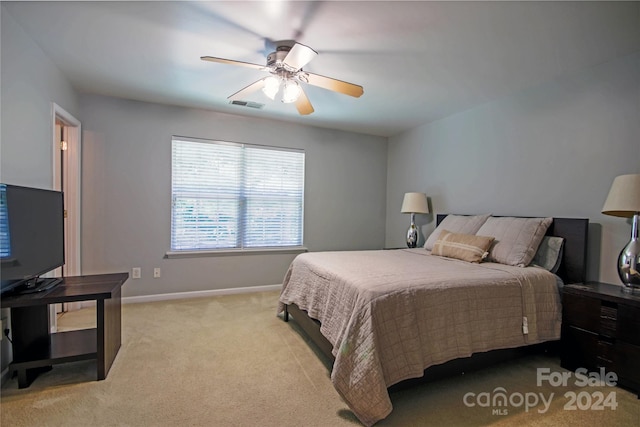 bedroom featuring light carpet and ceiling fan