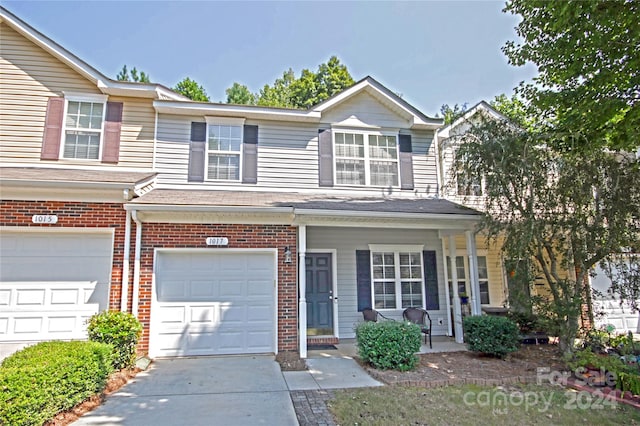 view of property featuring a garage and a porch