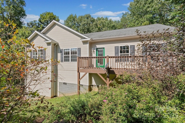 back of house featuring crawl space and a deck