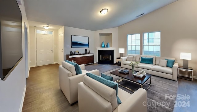 living room with vaulted ceiling and wood-type flooring