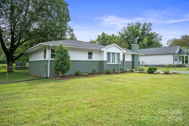 ranch-style house with a front lawn