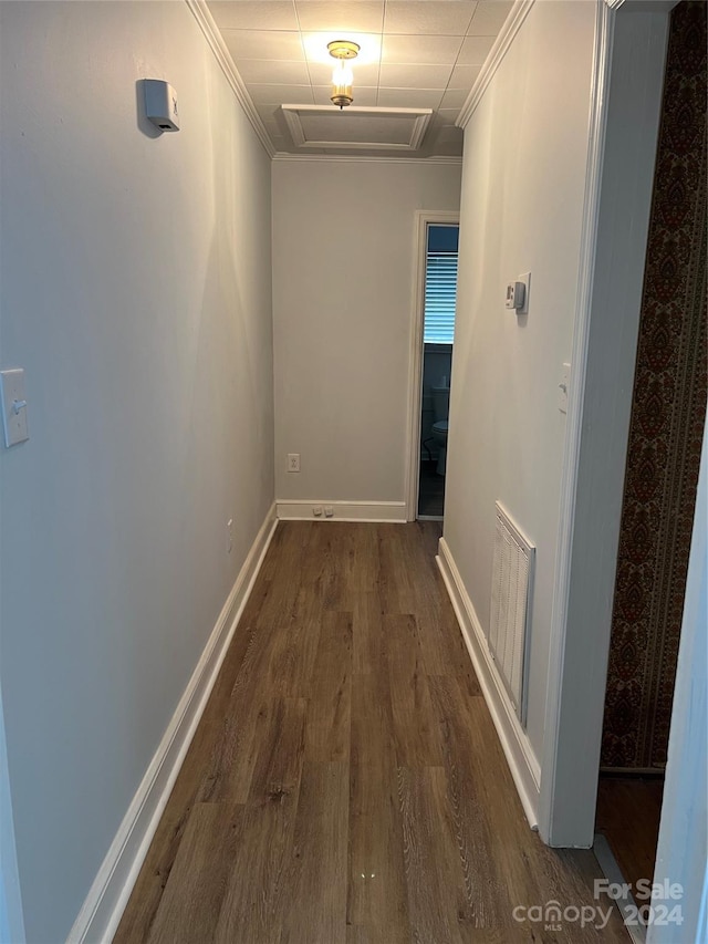 corridor featuring dark hardwood / wood-style floors and ornamental molding