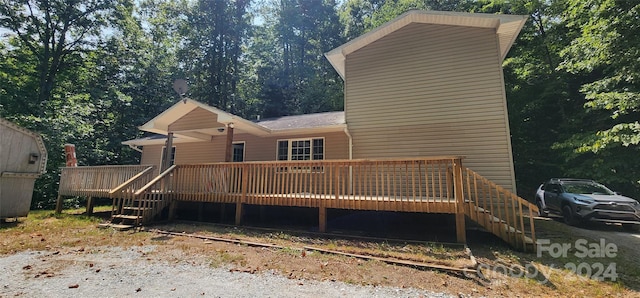 back of property featuring a deck