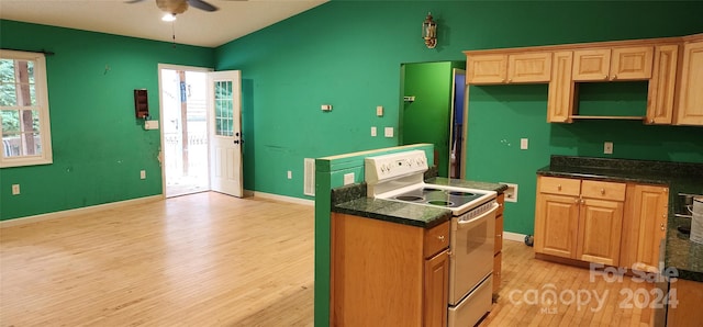 kitchen featuring light wood-type flooring, white range with electric cooktop, and ceiling fan