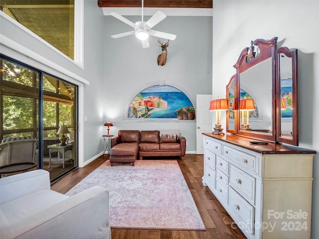 living room featuring high vaulted ceiling, dark wood-type flooring, beamed ceiling, and ceiling fan