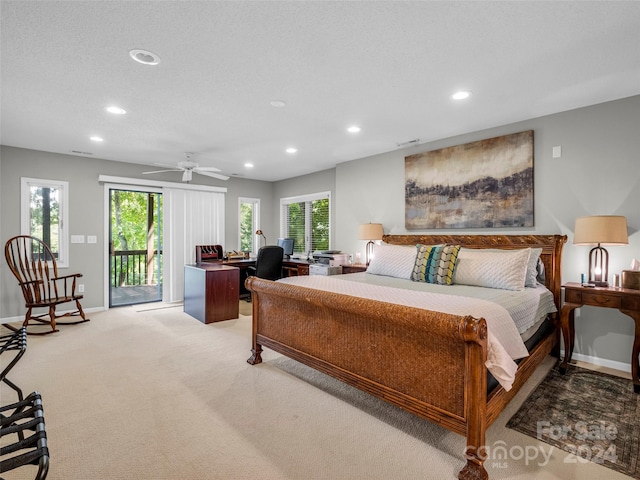 bedroom featuring ceiling fan, a textured ceiling, light carpet, and access to exterior