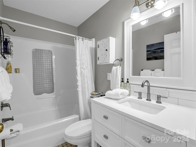 full bathroom with a textured ceiling, tasteful backsplash, shower / tub combo with curtain, vanity, and toilet