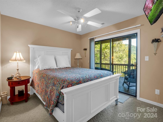 bedroom with a textured ceiling, access to outside, ceiling fan, and light carpet