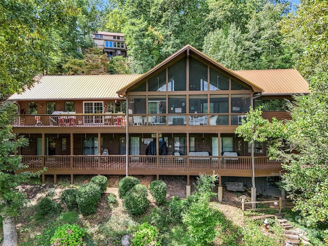 rear view of house featuring a sunroom