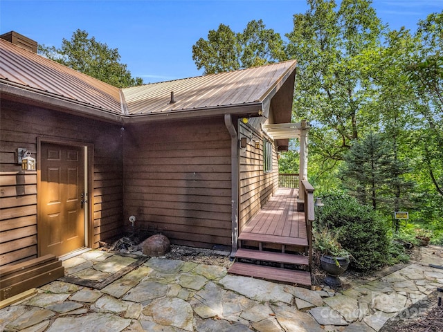 view of home's exterior featuring metal roof and a wooden deck