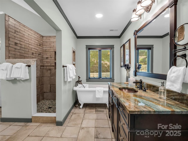 bathroom featuring ornamental molding, tile patterned flooring, walk in shower, a freestanding bath, and vanity